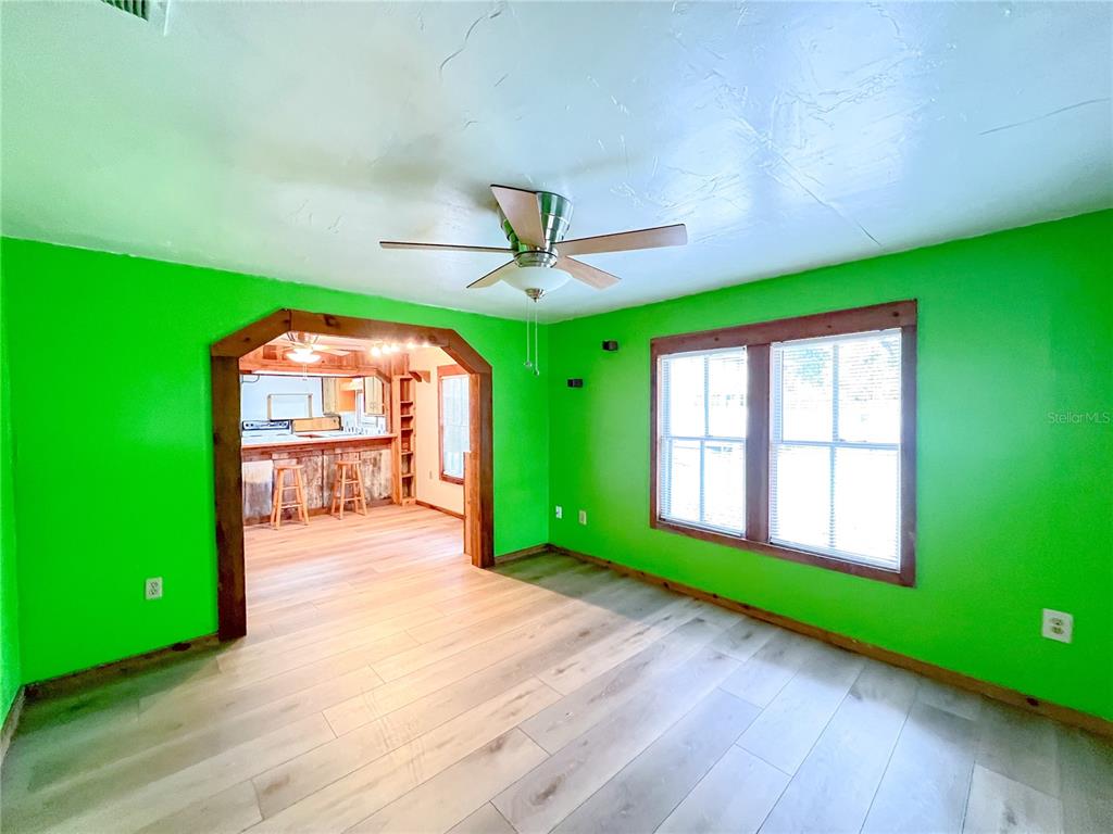 25825 West Newberry Road Newberry, FL 32669 - Photo 3 of 16 a yellow room with lots of windows and a wooden deck