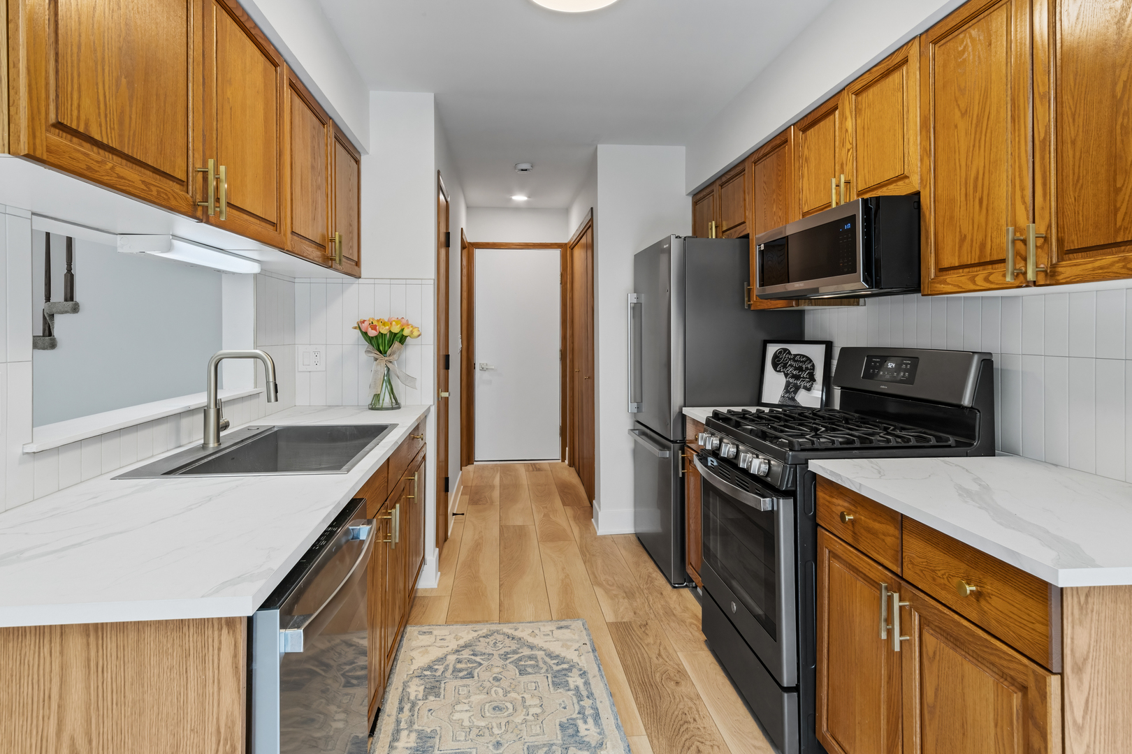 14710 Kenton Avenue Midlothian, IL 60445 - Photo 15 of 20 a kitchen with stainless steel appliances granite countertop a sink stove refrigerator and cabinets
