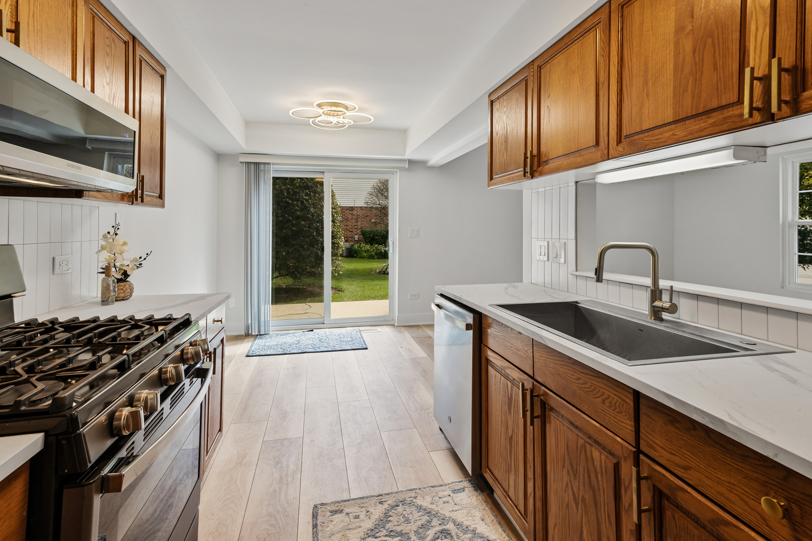 14710 Kenton Avenue Midlothian, IL 60445 - Photo 16 of 20 a kitchen with granite countertop a sink stove and cabinets