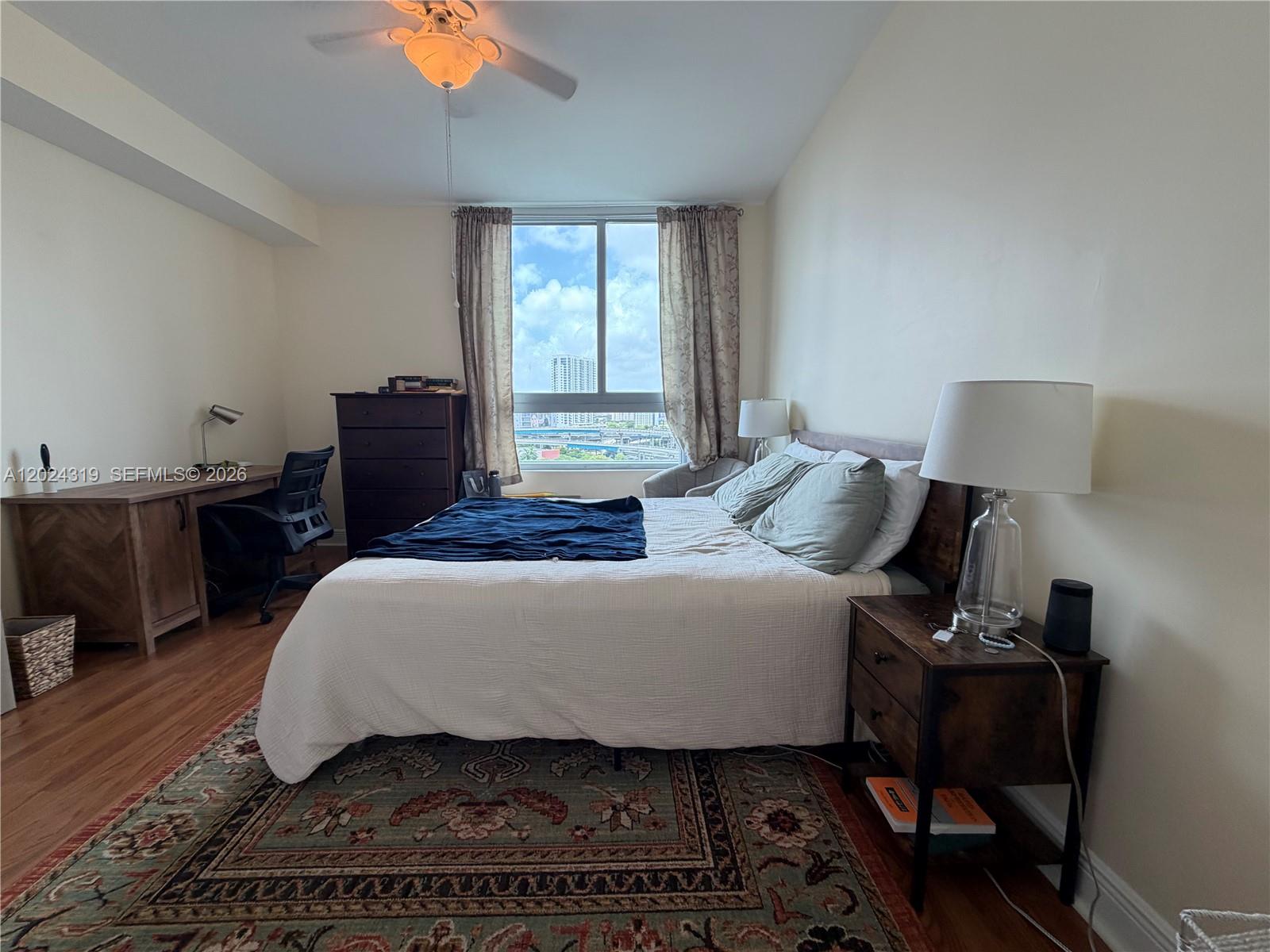90 Southwest 3rd Street, Unit 1409 Miami, FL 33130 - Photo 13 of 25 a bedroom with a bed and a window