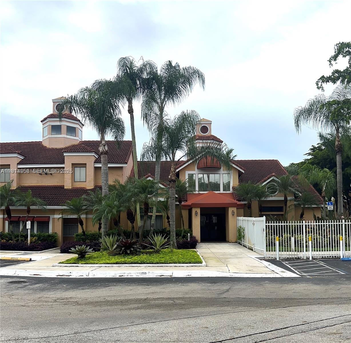 a front view of a residential apartment building with a yard