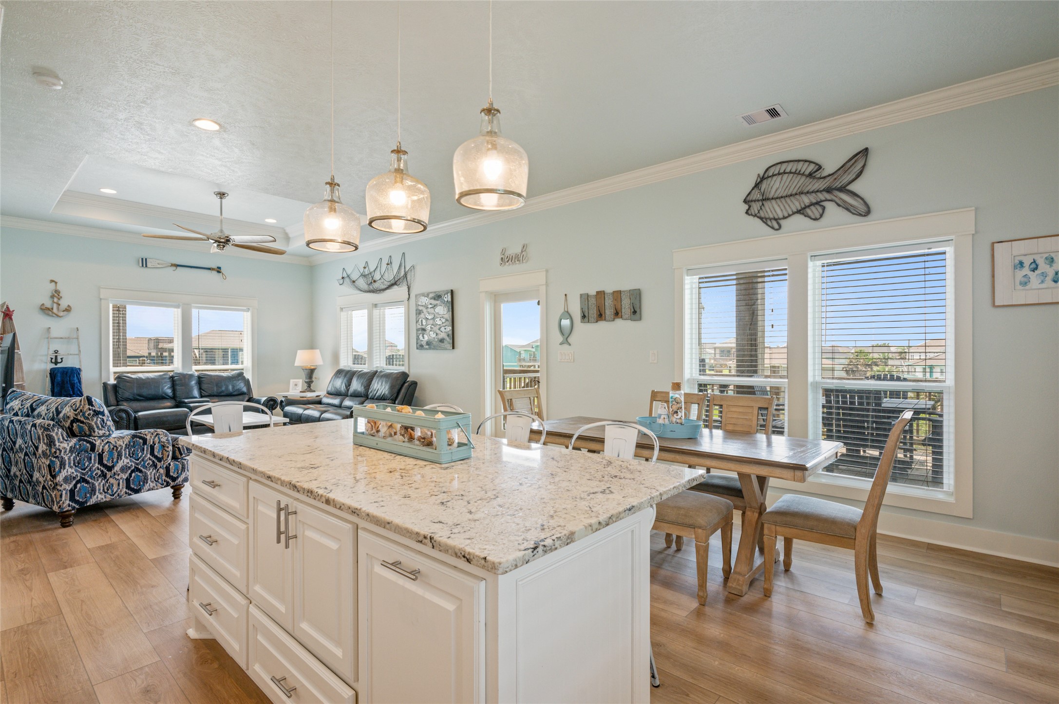 982 South Redfish Crystal Beach, TX 77650 - Photo 24 of 44 a view of a dining room with furniture and wooden floor