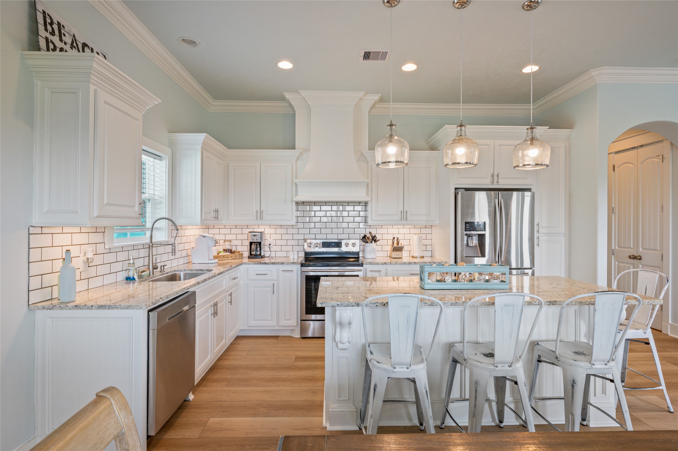 982 South Redfish Crystal Beach, TX 77650 - Photo 25 of 44 a kitchen with a sink window and cabinets