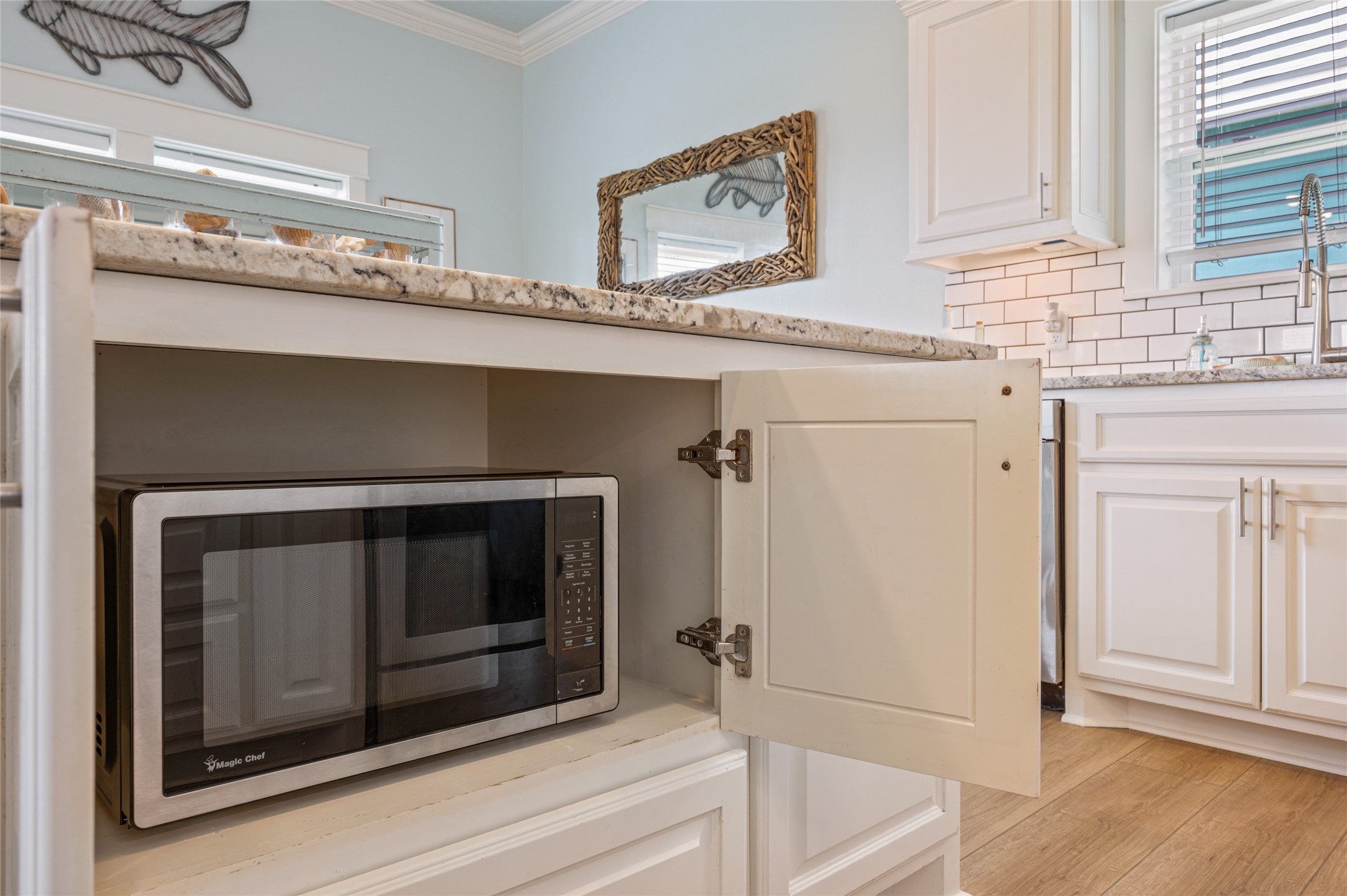 982 South Redfish Crystal Beach, TX 77650 - Photo 28 of 44 a bathroom with washing machine and cabinets
