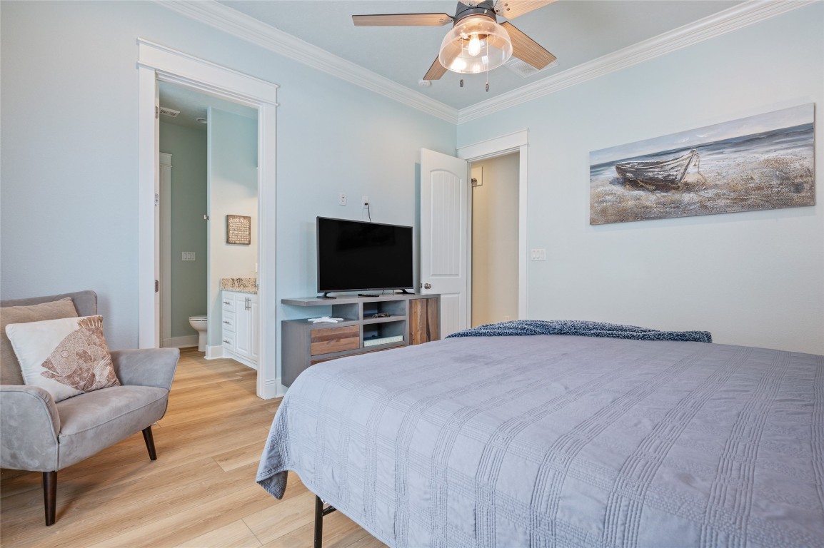 982 South Redfish Crystal Beach, TX 77650 - Photo 30 of 44 a bedroom with a bed and a flat screen tv
