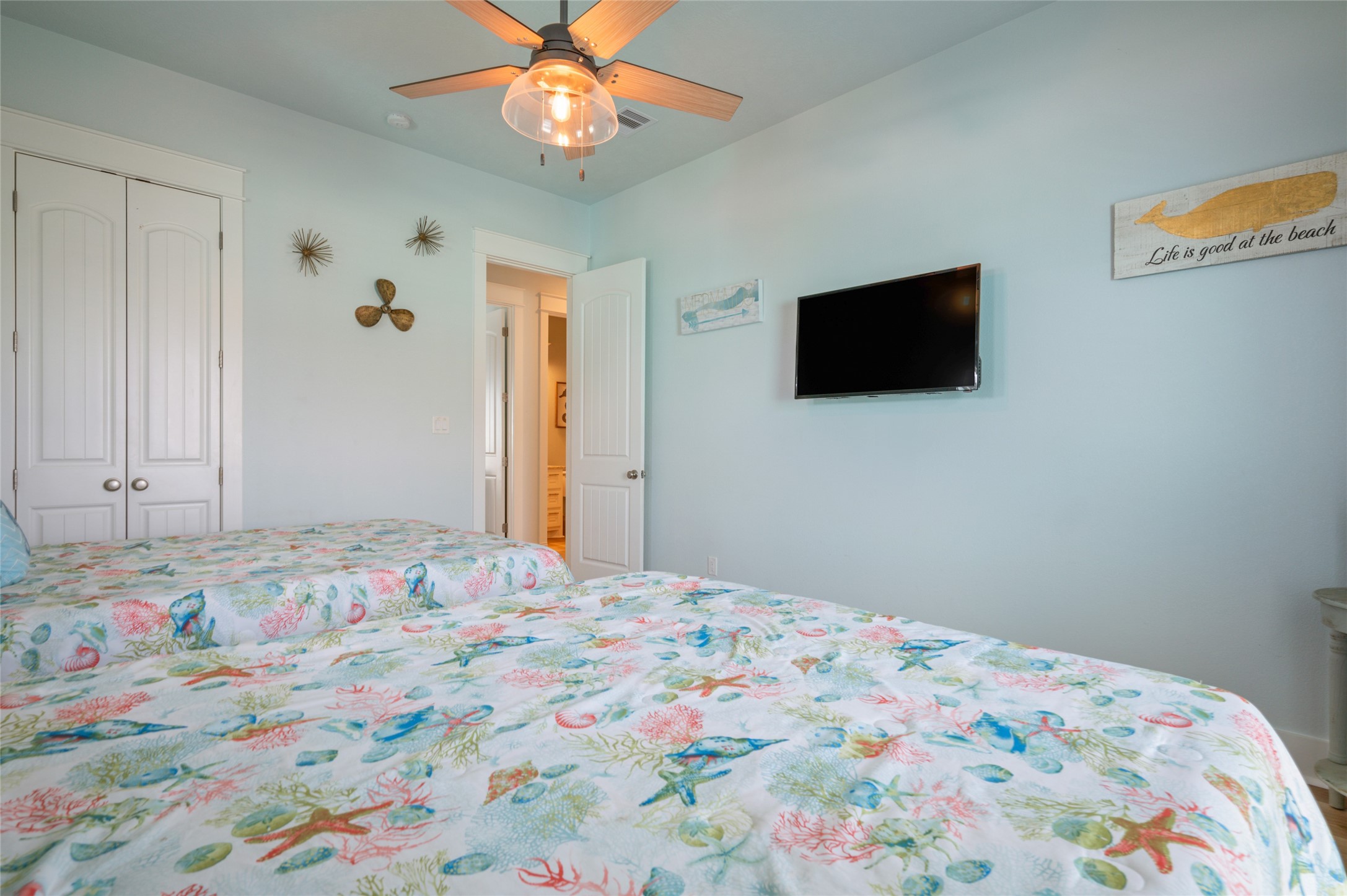 982 South Redfish Crystal Beach, TX 77650 - Photo 38 of 44 a bedroom with a bed and a flat screen tv