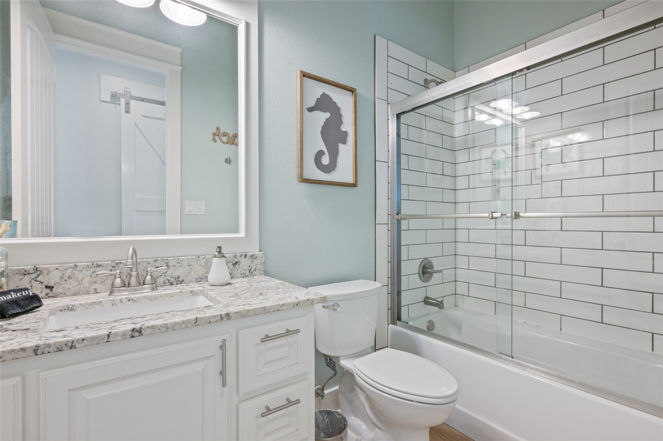 982 South Redfish Crystal Beach, TX 77650 - Photo 39 of 44 a bathroom with a granite countertop sink toilet and shower