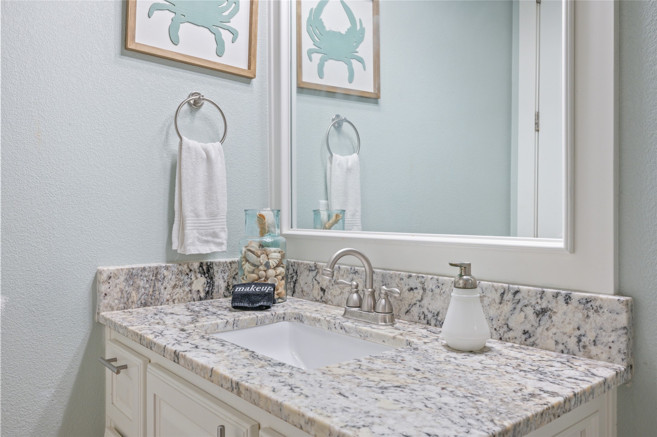 982 South Redfish Crystal Beach, TX 77650 - Photo 40 of 44 a bathroom with a granite countertop sink and a mirror
