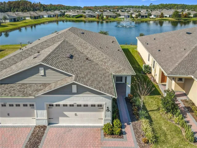 an aerial view of a house with a lake view