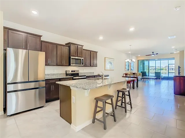 a kitchen with stainless steel appliances granite countertop a sink and a stove top oven