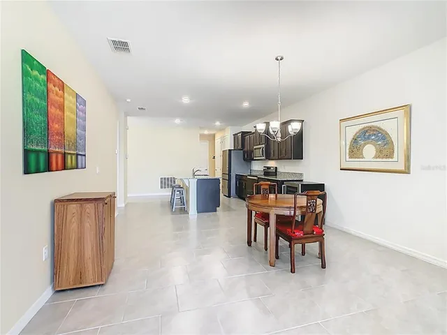 a living room with furniture kitchen view and a flat screen tv