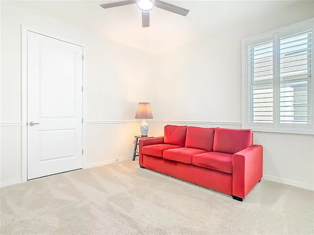 a bathroom with a granite countertop sink a toilet and a mirror