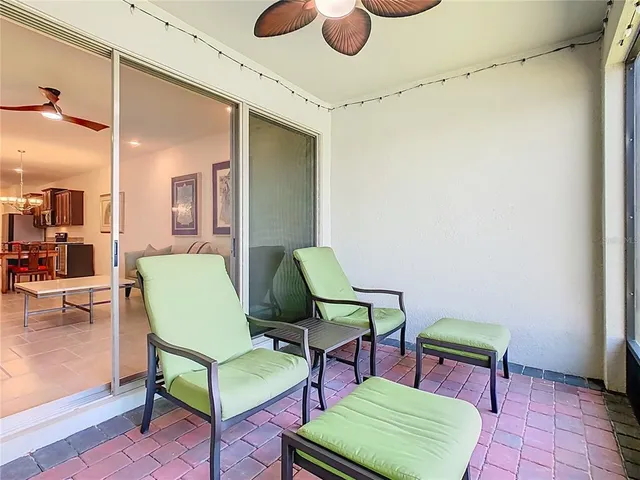 an aerial view of a house with a yard and large tree