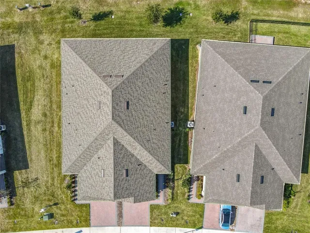 an aerial view of residential houses with outdoor space