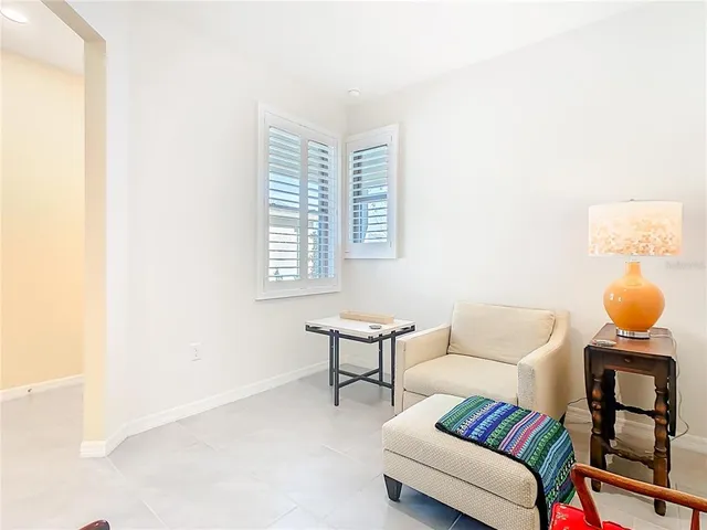 a kitchen with stainless steel appliances granite countertop a refrigerator a stove a sink a dining table and chairs