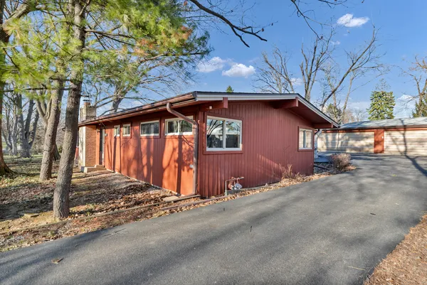 a view of a house with wooden fence