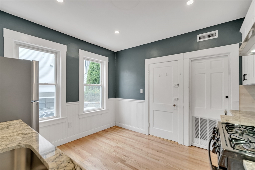 701 Hammond Street, Unit 1 Brookline, MA 02467 - Photo 11 of 28 a view of empty room with wooden floor and fan