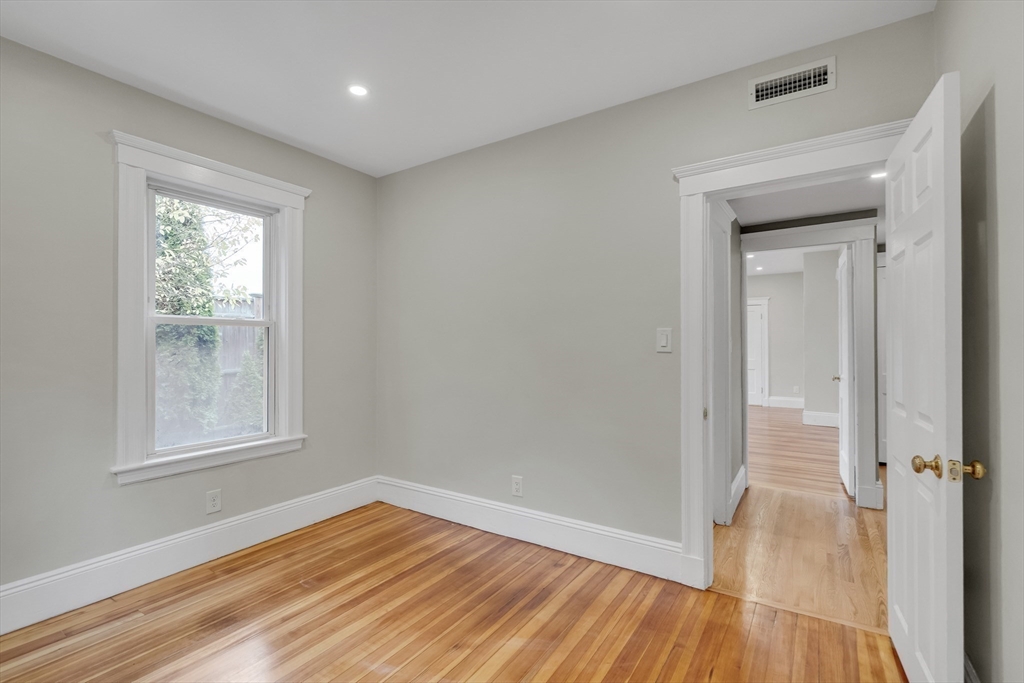 701 Hammond Street, Unit 1 Brookline, MA 02467 - Photo 15 of 28 a view of a room with wooden floor and window