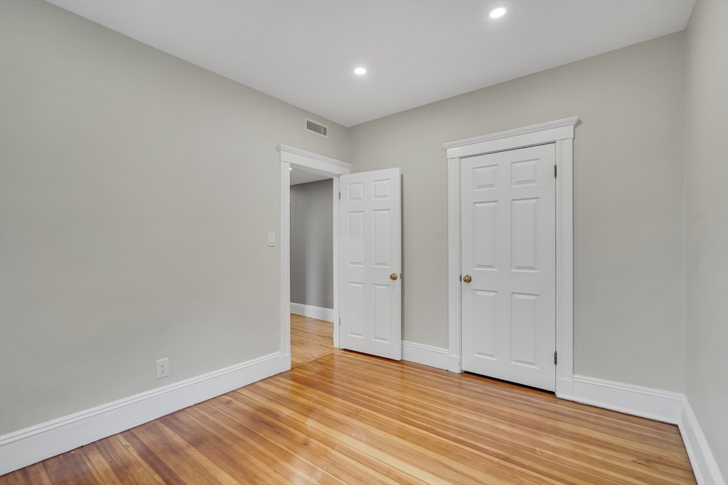 701 Hammond Street, Unit 1 Brookline, MA 02467 - Photo 16 of 28 a view of an empty room with wooden floor