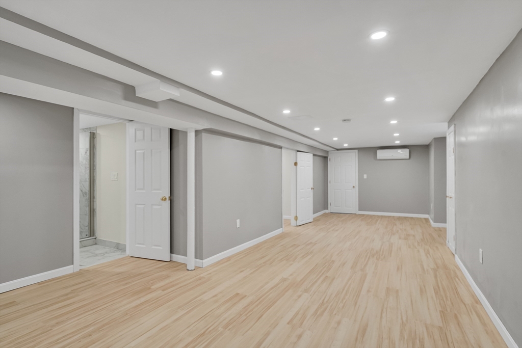 701 Hammond Street, Unit 1 Brookline, MA 02467 - Photo 19 of 28 a view of an empty room with wooden floor