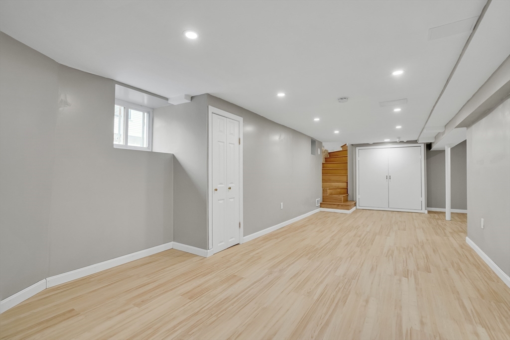 701 Hammond Street, Unit 1 Brookline, MA 02467 - Photo 20 of 28 a view of an empty room with wooden floor and a window