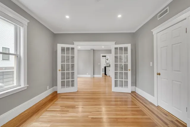 a view of a room with wooden floor and windows