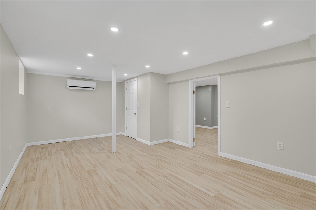 701 Hammond Street, Unit 1 Brookline, MA 02467 - Photo 21 of 28 a view of an empty room with wooden floor and a window