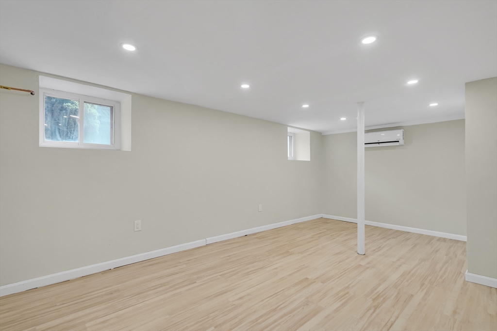 701 Hammond Street, Unit 1 Brookline, MA 02467 - Photo 22 of 28 an empty room with wooden floor and windows