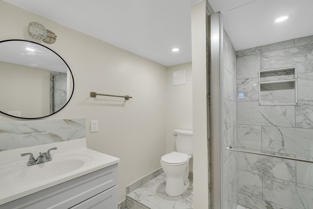 701 Hammond Street, Unit 1 Brookline, MA 02467 - Photo 23 of 28 a bathroom with a sink a toilet and a mirror
