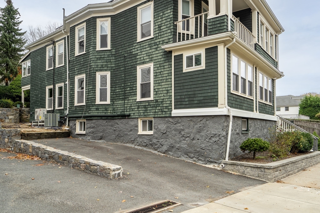 701 Hammond Street, Unit 1 Brookline, MA 02467 - Photo 26 of 28 a front view of a house with a yard