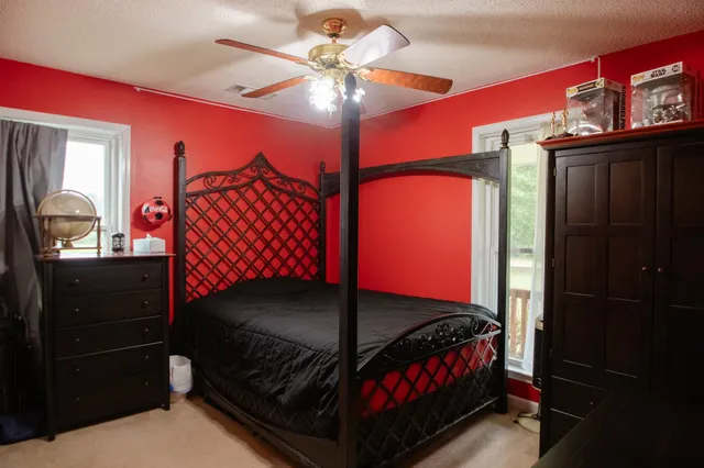 a bed sitting in a bedroom next to a window