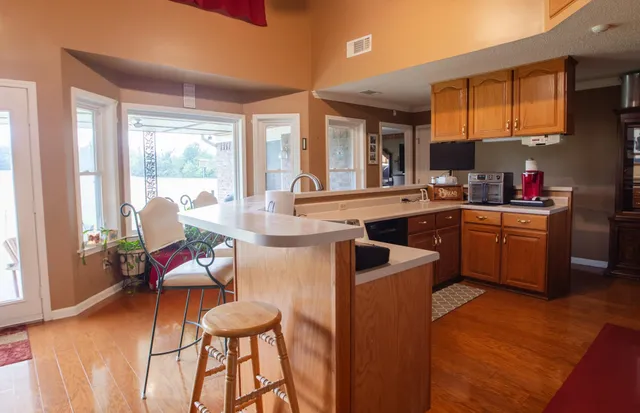 a large kitchen with a table and chairs in it
