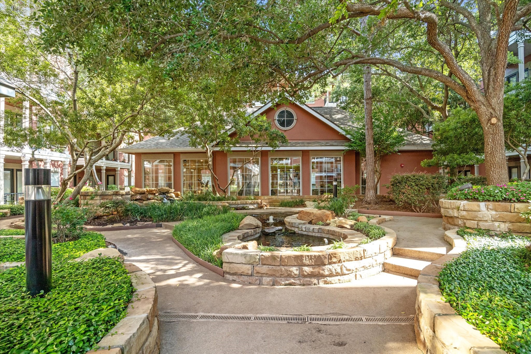 2400 McCue Road, Unit 460 Houston, TX 77056 - Photo 20 of 21 a front view of a house with yard fountain and green space