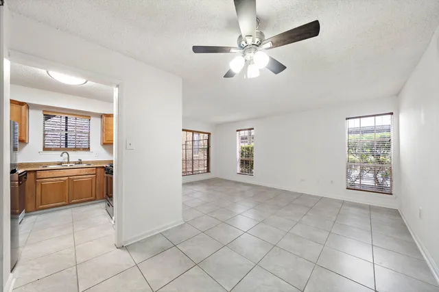 a view of an empty room with a kitchen