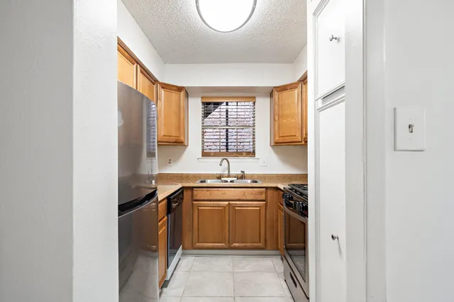 a kitchen with a sink stove and cabinets