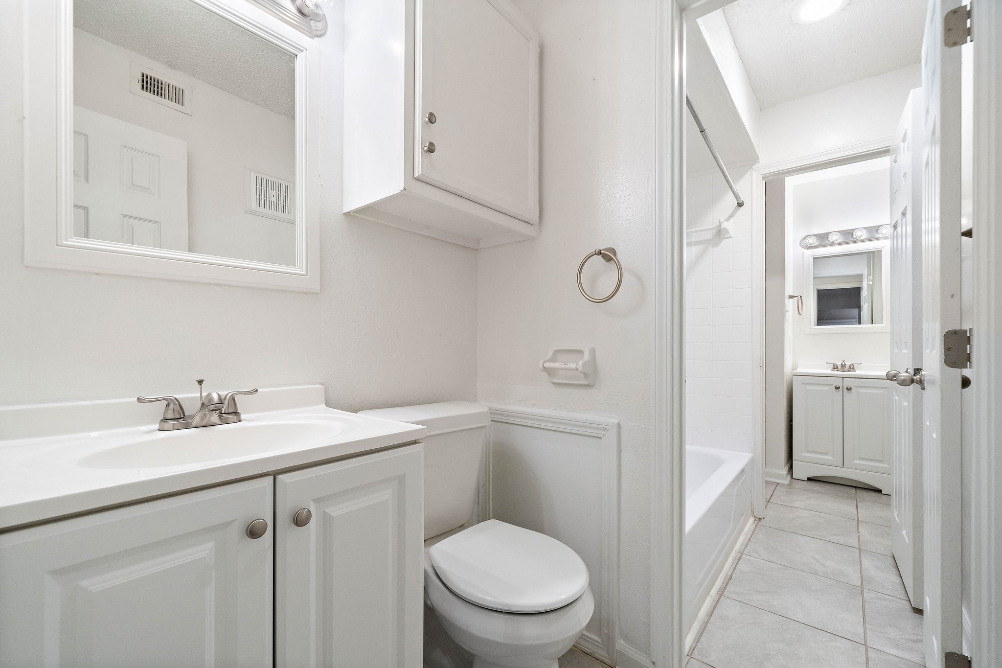711 Holiday Drive, Unit 63 Galveston, TX 77550 - Photo 10 of 10 a bathroom with a toilet sink vanity and mirror