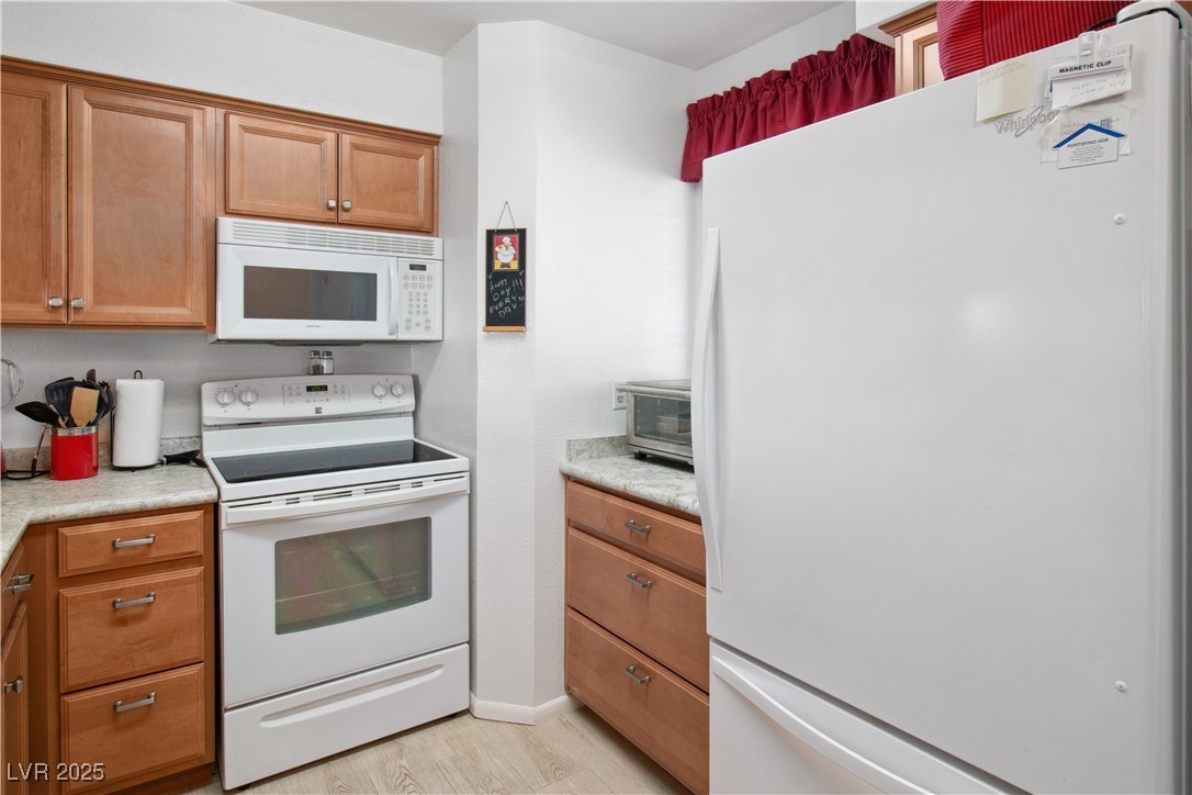 2044 Mesquite Lane, Unit 302 Laughlin, NV 89029 - Photo 6 of 45 The Kitchen has a white fridge / freezer, microwav