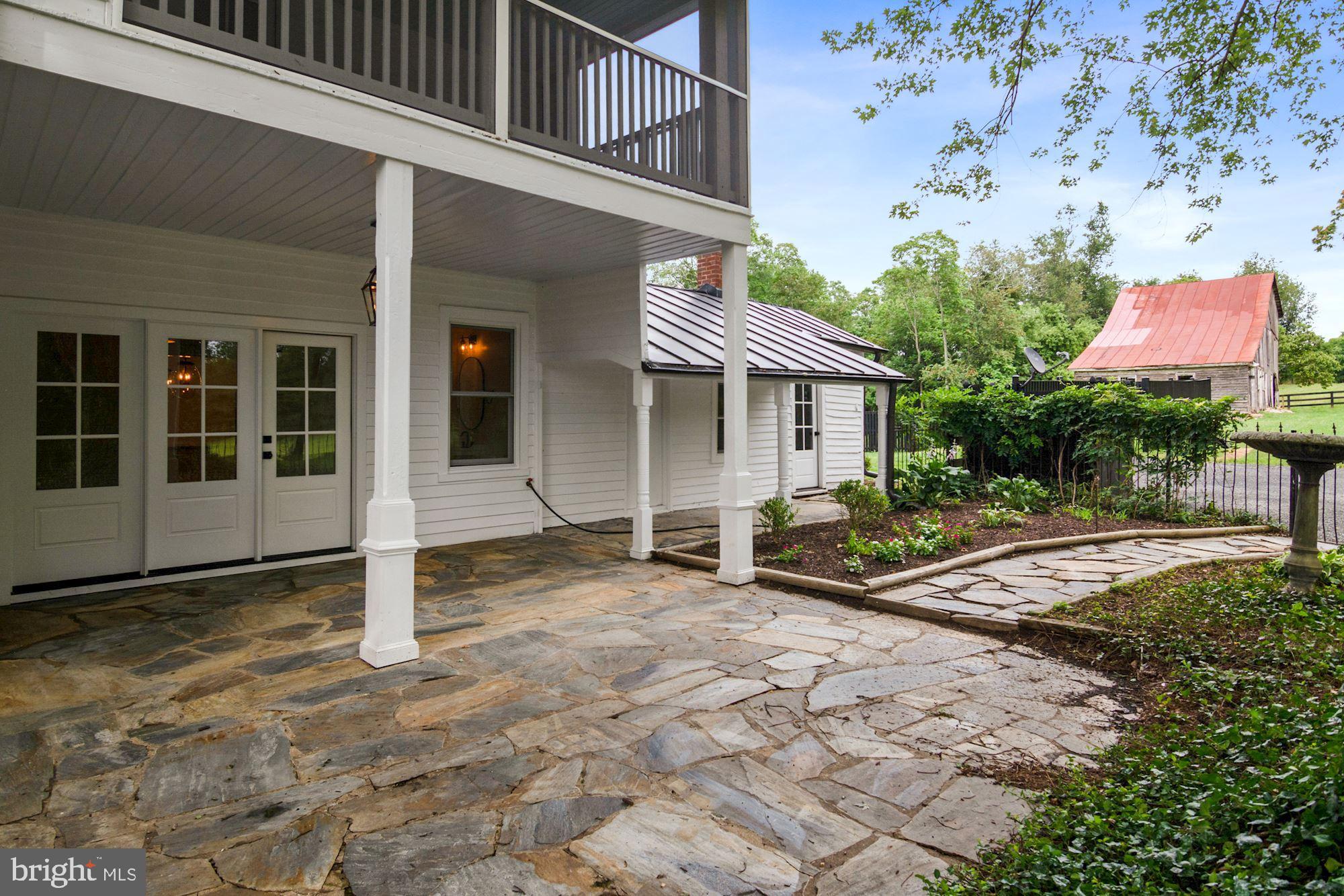 7021 Leeds Manor Road Marshall, VA 20115 - Photo 14 of 31 Flagstone courtyard, covered porch, iron fence