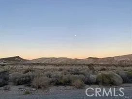a view of a mountain with mountains in the background