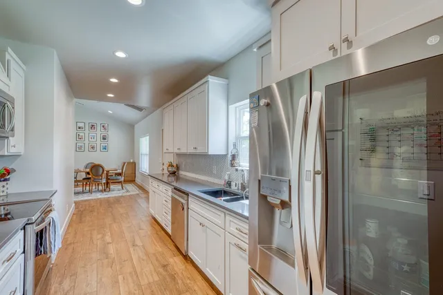 a kitchen with stainless steel appliances a refrigerator and a sink