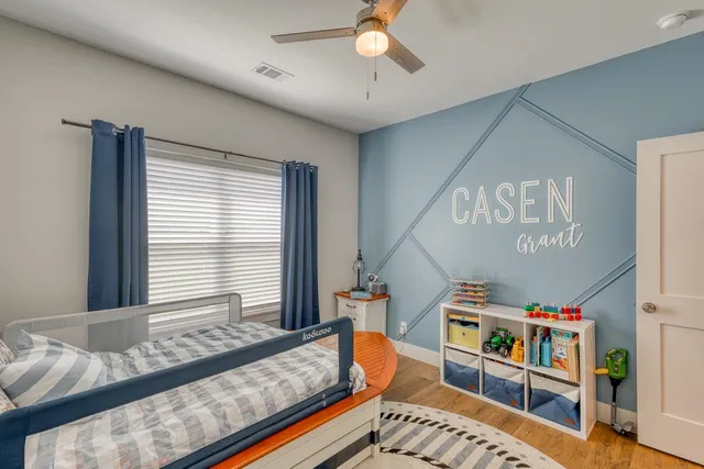 a bedroom with furniture and a book shelf