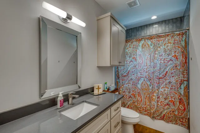 a bathroom with a sink toilet and shower