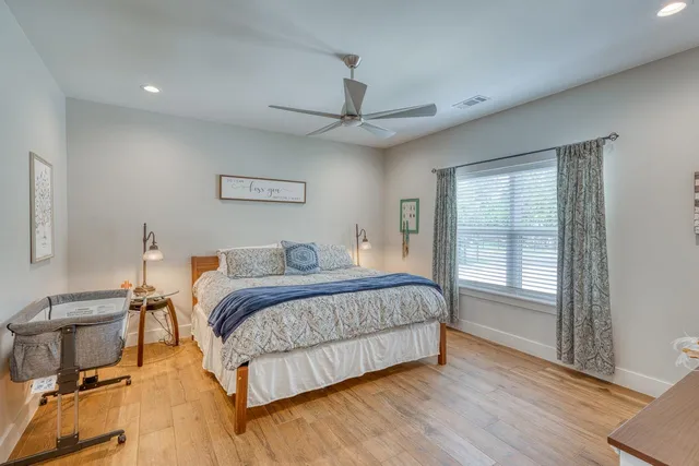 a bedroom with a large bed and a chandelier