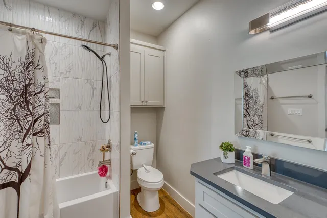 a bathroom with a sink toilet and shower