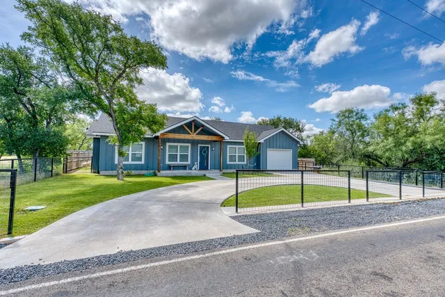 a front view of house with yard and entertaining space