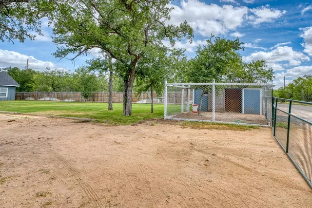 an aerial view of a house with outdoor space lake view and ocean view