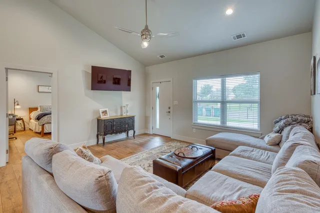 a living room with furniture a couch and a window
