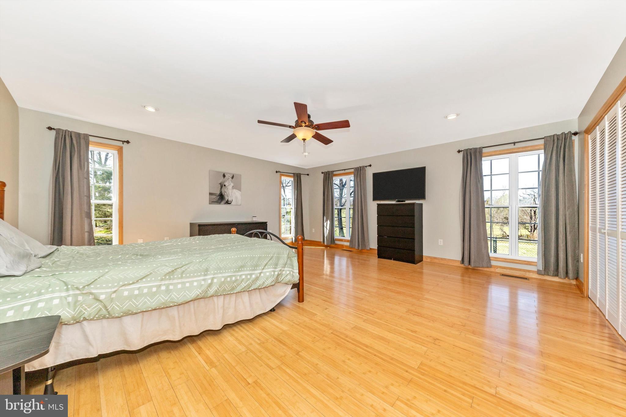 17449 Irishtown Road Emmitsburg, MD 21727 - Photo 16 of 77 a bedroom with a large bed a flat tv screen and dresser