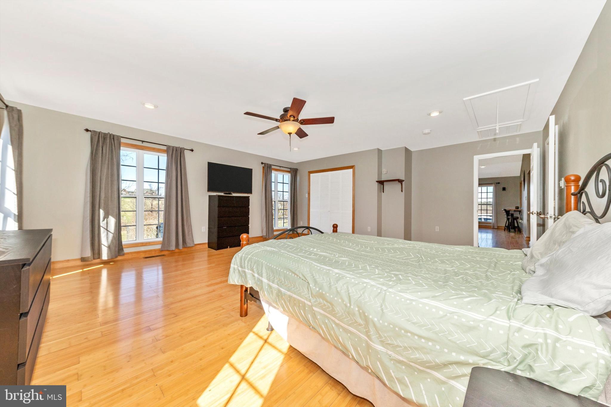 17449 Irishtown Road Emmitsburg, MD 21727 - Photo 19 of 77 a spacious bedroom with a bed and dresser with wooden floor