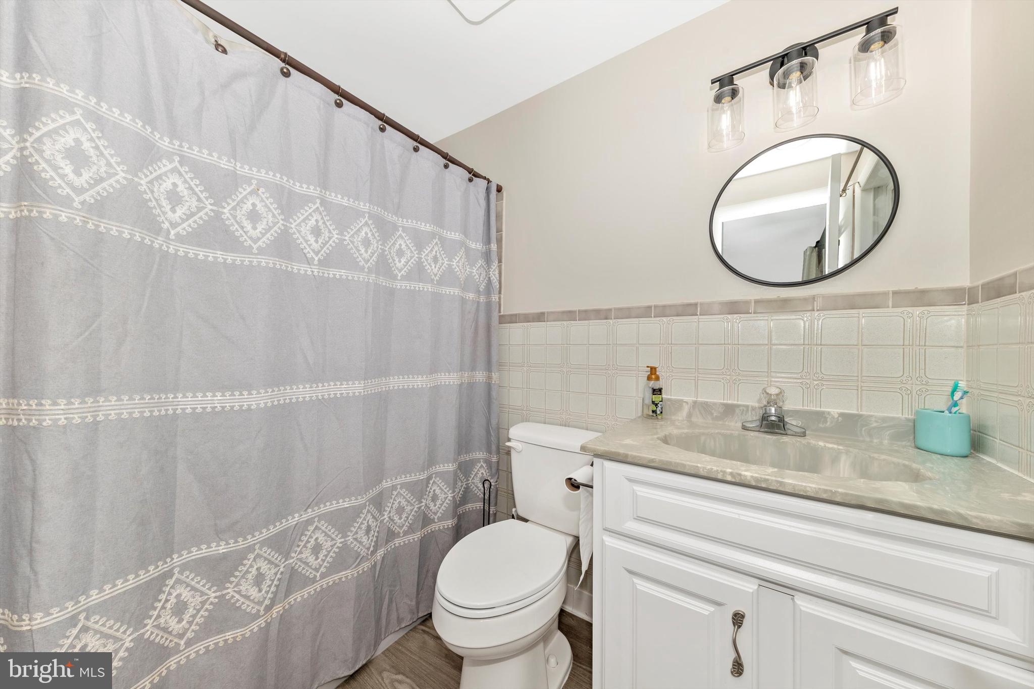 17449 Irishtown Road Emmitsburg, MD 21727 - Photo 27 of 77 a bathroom with a granite countertop toilet sink and mirror